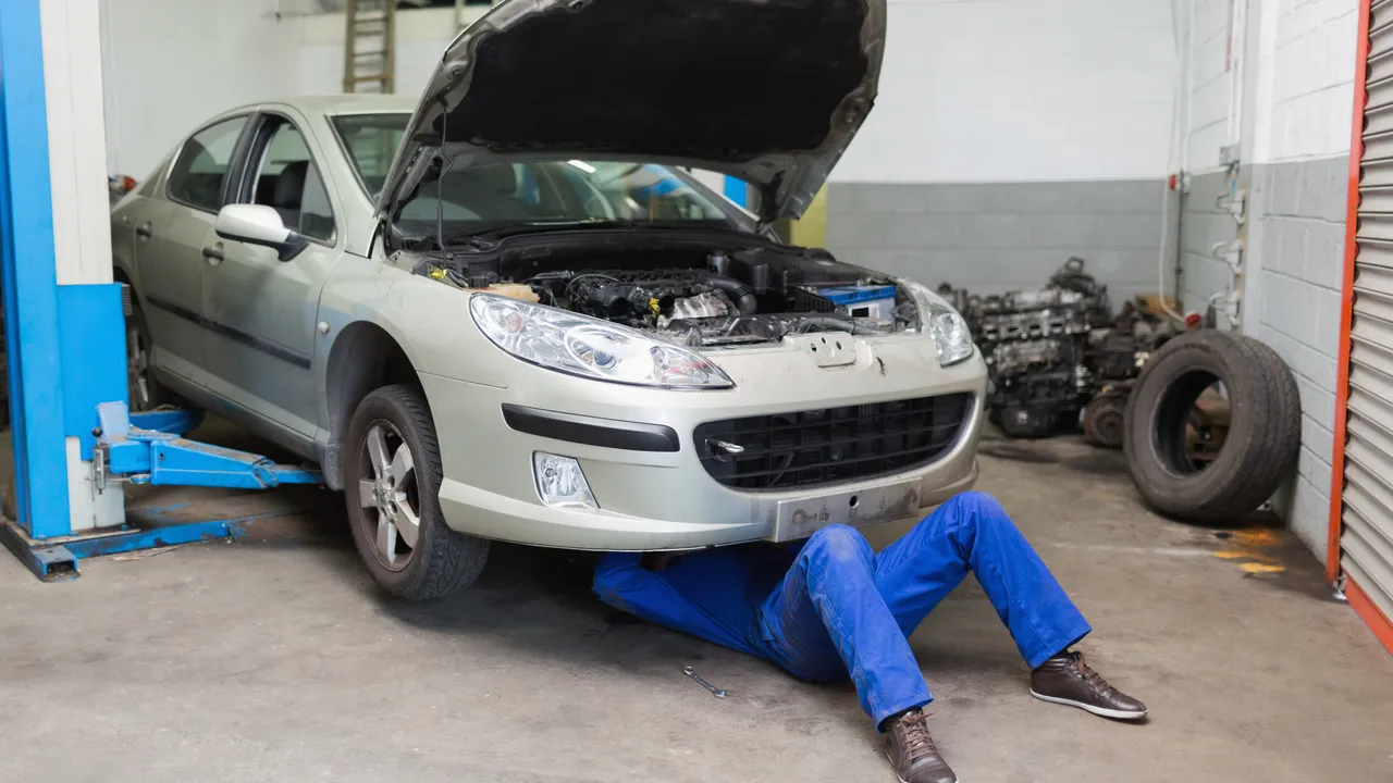 blue bowl of black bean beef tortilla soup on a board with cilantro and shredded cheese in background